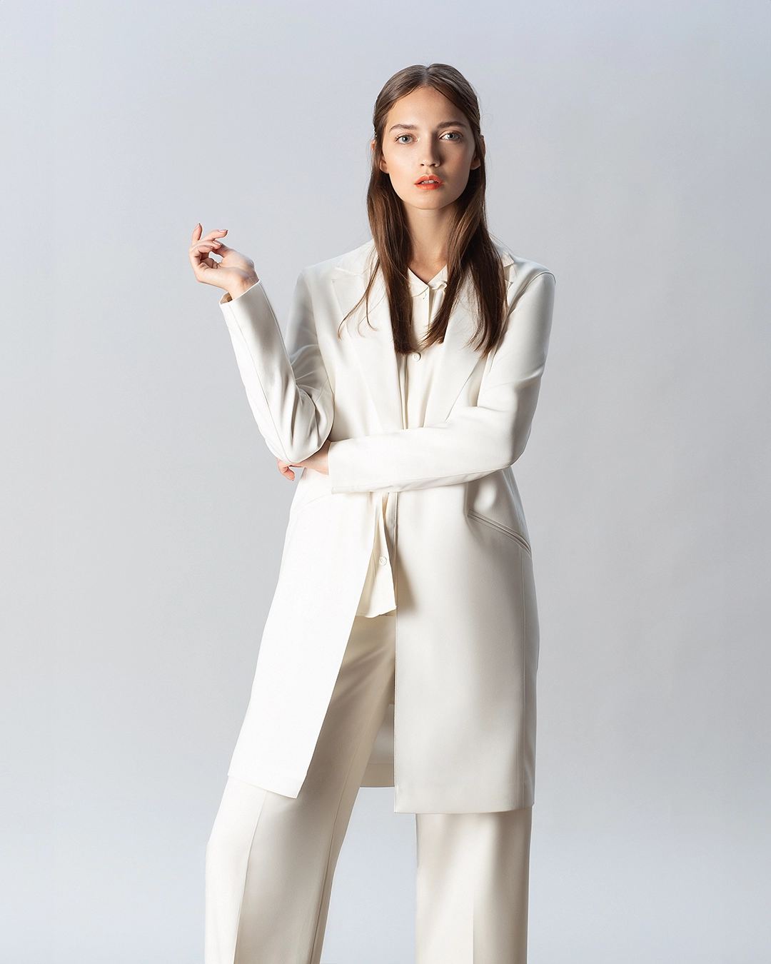 White woman suit retouched — folds removed and fabric contour corrected