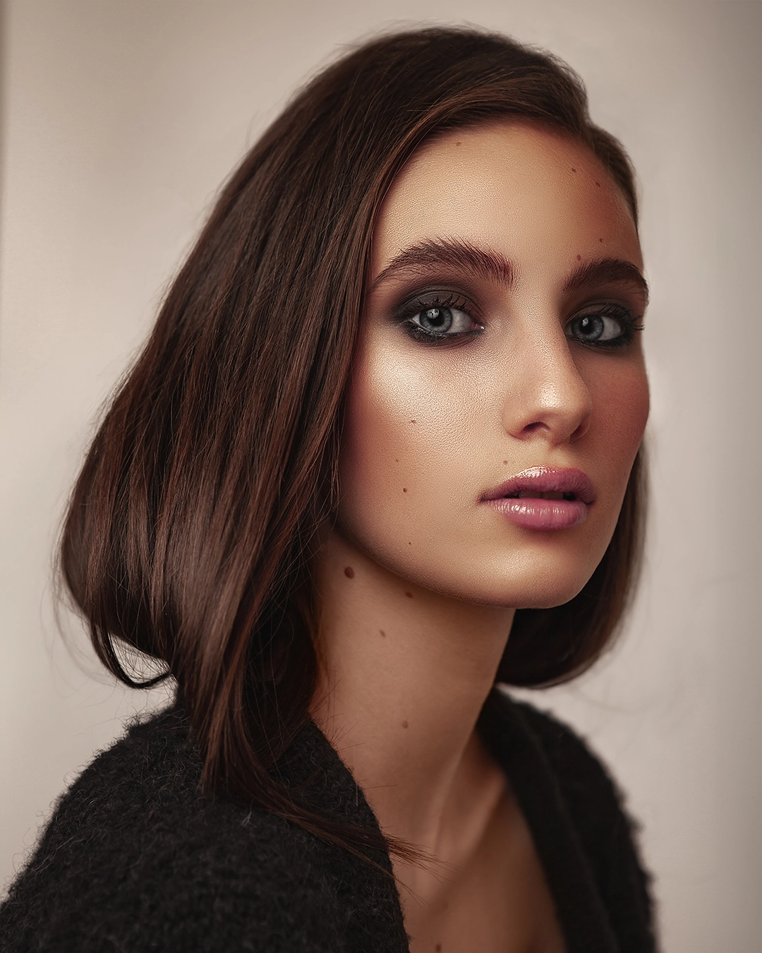 Close-up portrait with even skin, natural glow, and soft shadows