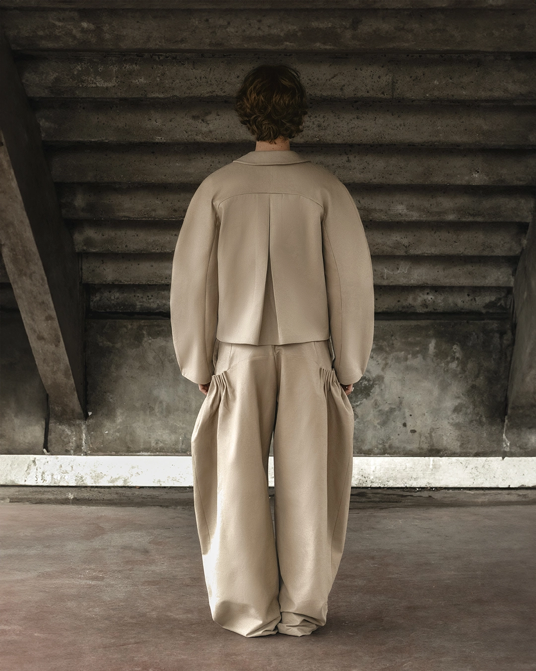 After retouching — smooth fabric on jacket and pants and sharpened garment fit on model